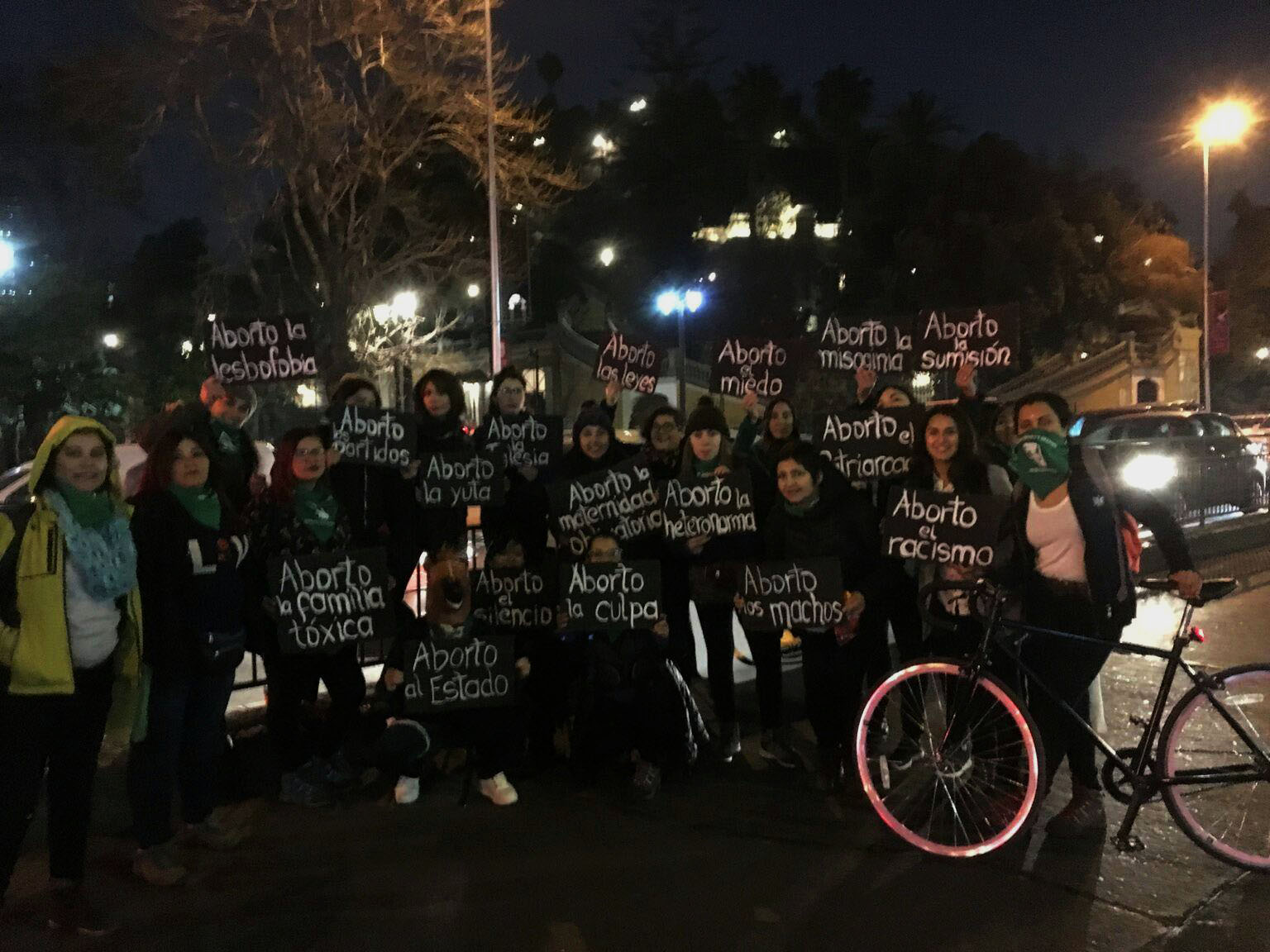 Fotografía de una marcha por la Alameda con el cerro Huelen de fondo, en la fotografía aparece un grupo de mujeres con distintos carteles que dicen Aborto a…, dentro de los carteles que alcanzan a leerse dicen: aborto la lesbofobia, aborto el miedo, aborto la maternidad obligatoria, aborto el patriarcado, aborto la misoginia, aborto la sumisión, aborto la familia tóxica, aborto el Estado, aborto la culpa, aborto el silencio, aborto la iglesia, aborto la yuta, aborto la heteronorma, aborto a los machos, aborto los partidos.